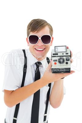 Geeky hipster holding a retro camera