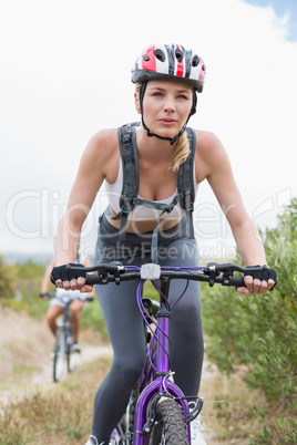 Fit couple cycling on mountain trail