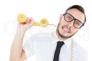 Geeky businessman being strangled by phone cord