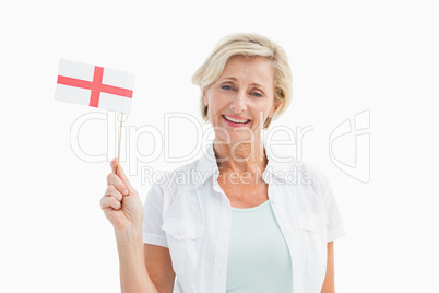 Happy mature woman holding english flag