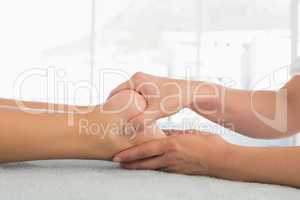 Woman receiving leg massage at spa center