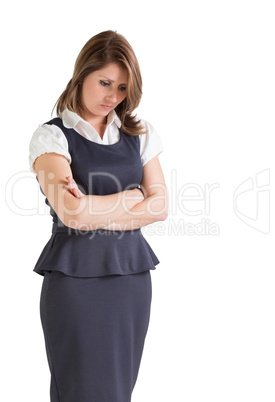 Thoughtful young businesswoman with arms crossed