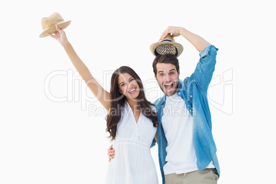 Happy hipster couple smiling at camera and cheering