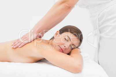 Attractive woman receiving back massage at spa center