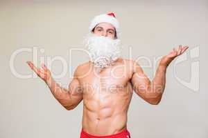 Portrait of shirtless macho man with fake santa beard