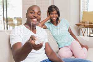 Happy couple relaxing on the couch watching tv