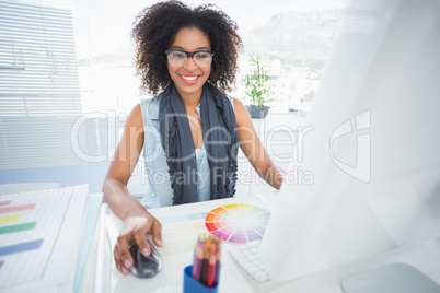 Pretty designer working at her desk Pretty designer working at her desk