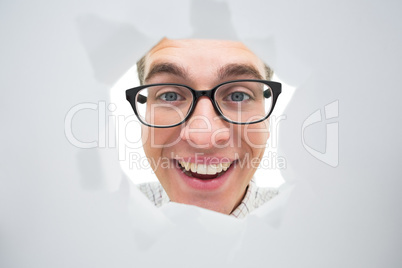Geeky hipster smiling through hole