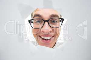 Geeky hipster smiling through hole