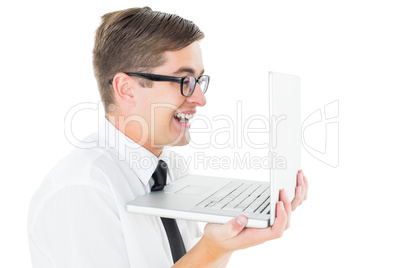 Geeky businessman holding his laptop