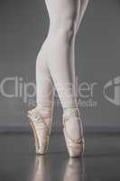 Ballerina standing en pointe in ballet slippers
