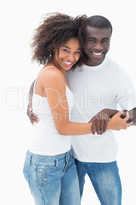 Attractive couple in matching clothes smiling at camera