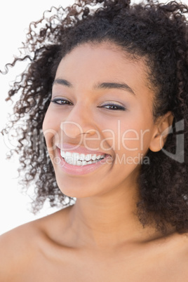 Pretty girl with afro hairstyle smiling at camera