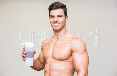 Close-up portrait of a sporty young man with protein drink