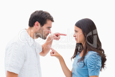 Angry couple pointing at each other