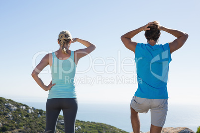 Fit couple standing looking out to sea