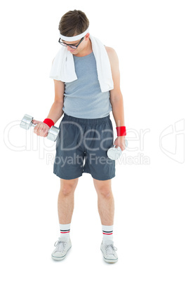 Geeky hipster lifting dumbbells in sportswear