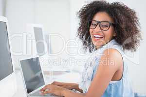 Pretty hipster working at her desk on laptop