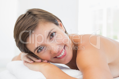 Beautiful woman lying on massage table at spa center