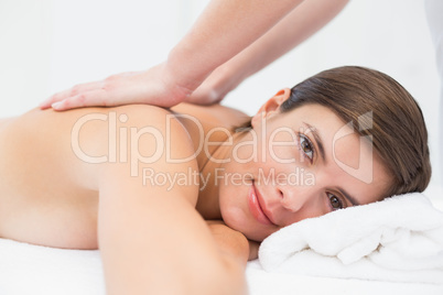 Attractive woman receiving back massage at spa center