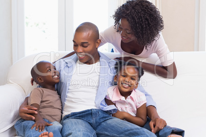 Happy family posing on the couch together