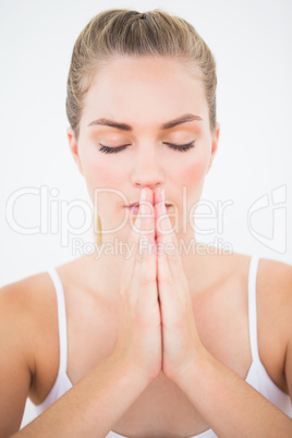 Peaceful blonde meditating with eyes closed