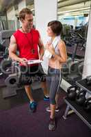 Handsome personal trainer speaking with his client