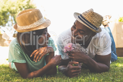 Happy couple lying in garden together