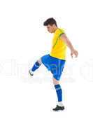 Football player in yellow kicking