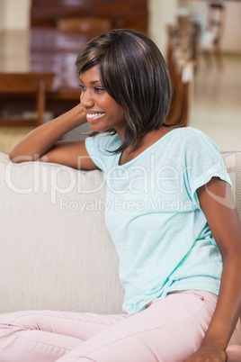 Smiling woman sitting on couch