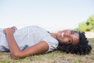 Casual pretty woman lying on the grass