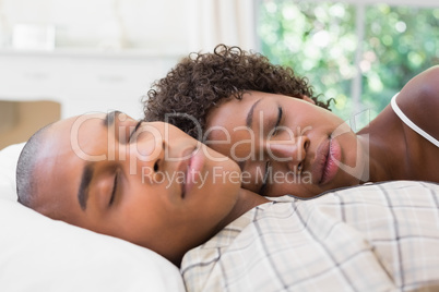 Happy couple sleeping in bed together Happy couple sleeping in bed together