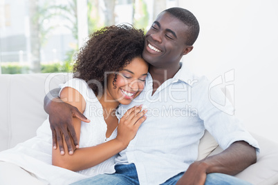 Attractive couple cuddling on the couch