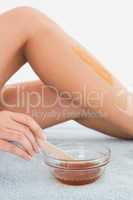 Female leg with hot wax at spa center