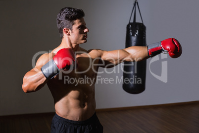 Male boxer attacking with his left in health club