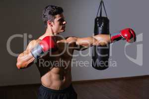 Male boxer attacking with his left in health club