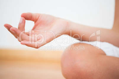 Peaceful woman sitting in lotus pose