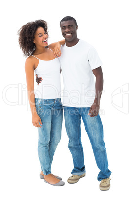 Casual couple in jeans and white tops posing