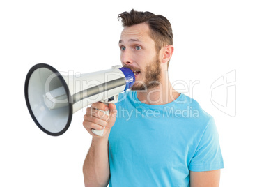 Handsome hipster talking through megaphone