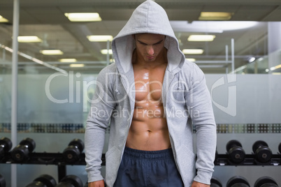 Muscular young man in hood jacket