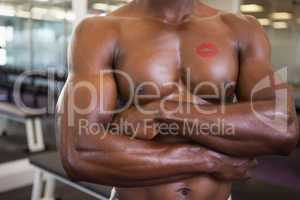 Shirtless muscular man with lipstick mark on chest