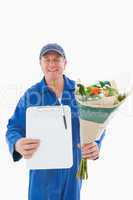 Happy flower delivery man showing clipboard