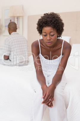 Unhappy couple not speaking to each other on bed