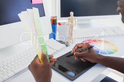Designer sitting at his desk working with digitizer