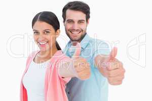 Happy couple showing thumbs up