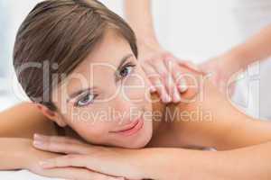 Attractive woman receiving back massage at spa center