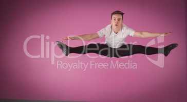 Focused male ballet dancer leaping doing the splits
