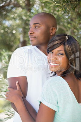 Happy couple hugging each other in garden