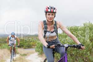 Fit couple cycling on mountain trail