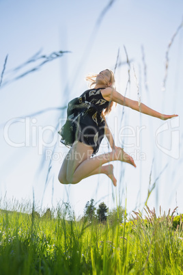 Pretty blonde in sundress jumping up